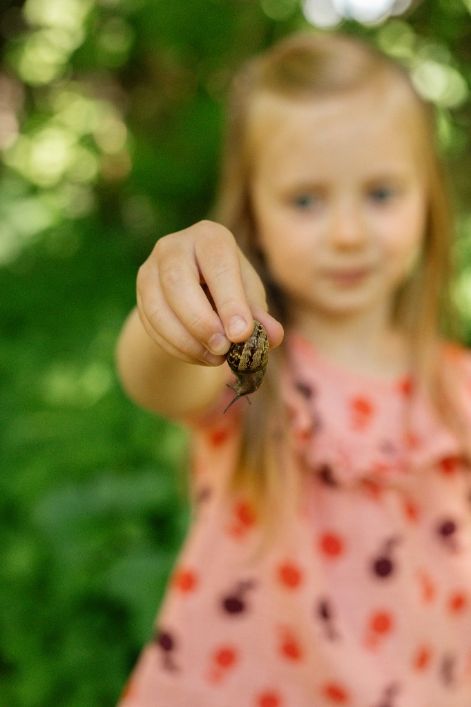 Child looking at snail